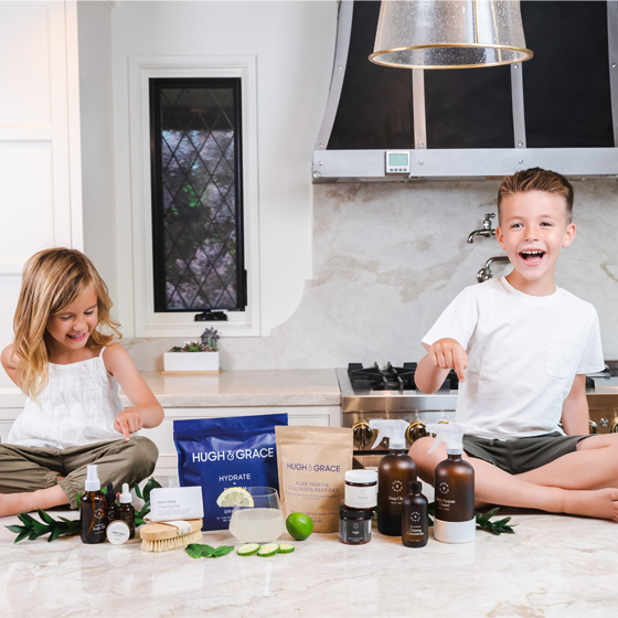 Smiling children around Hugh and Grace products